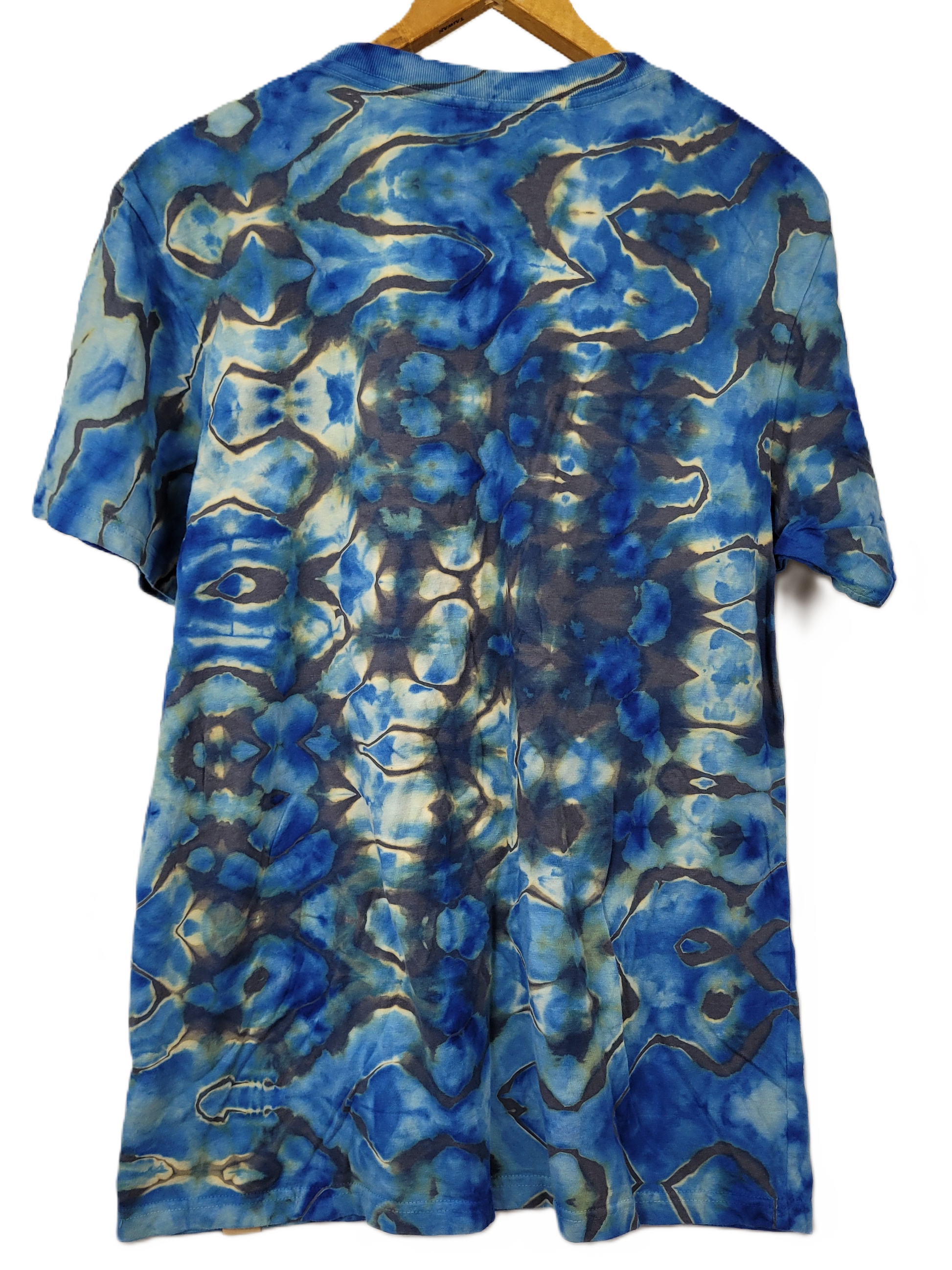Blue and gray tie-dye shirt on a hanger against a white background