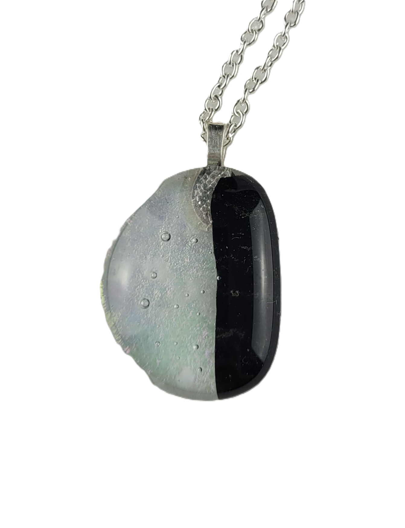 Necklace with a half-black, half-white pendant on a white background