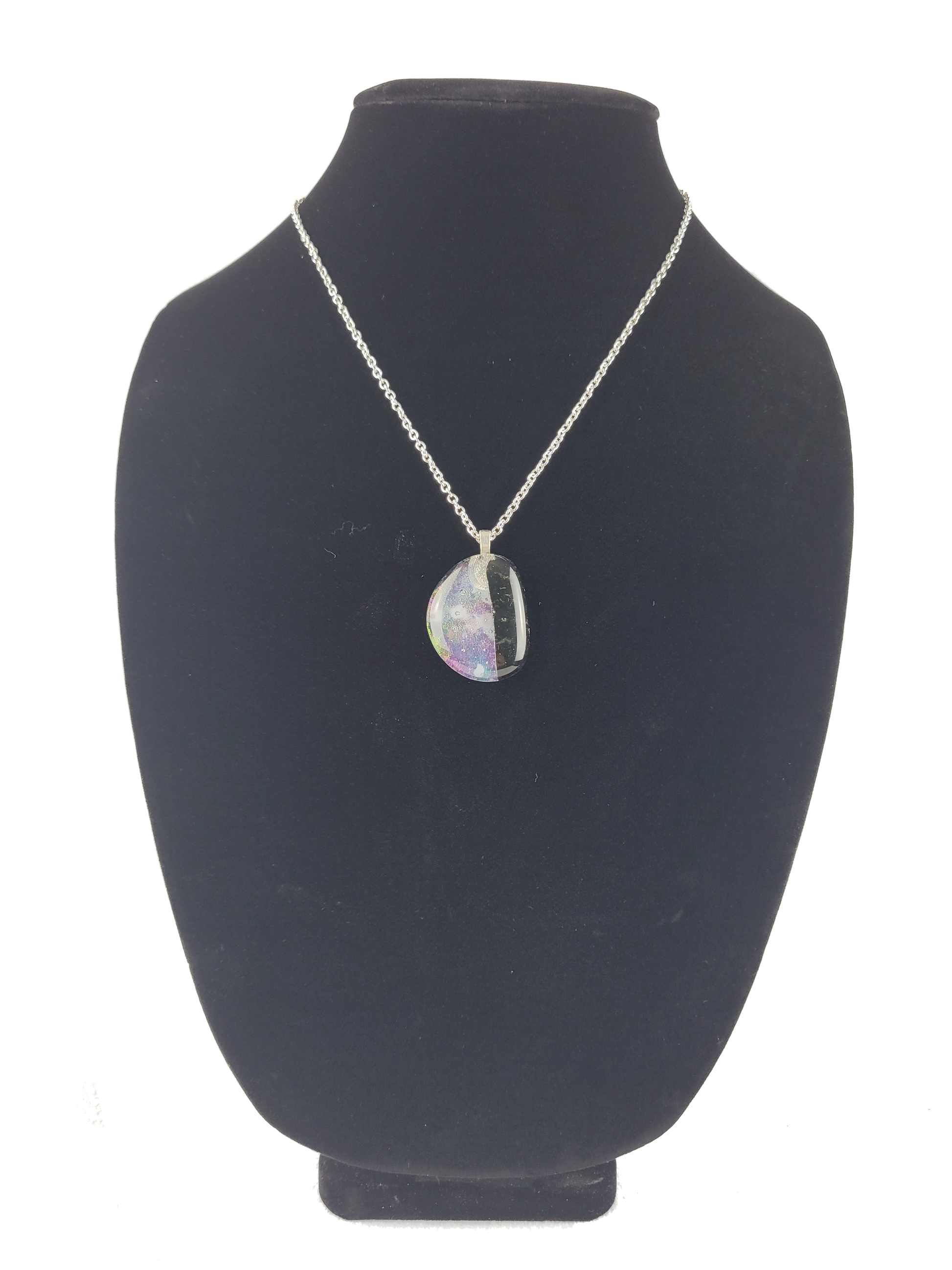 Necklace with a pendant on a black bust