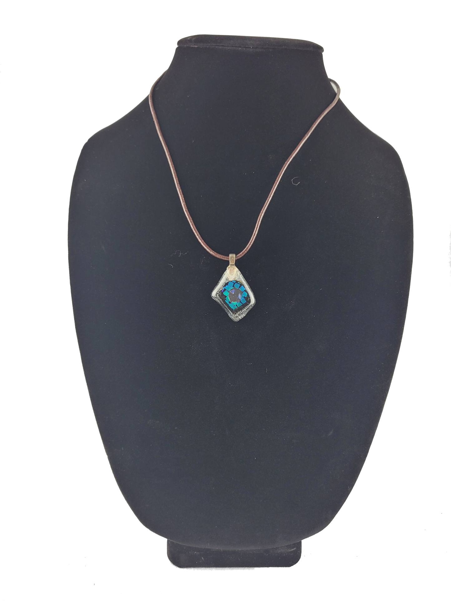 Necklace with a blue pendant on a black mannequin bust