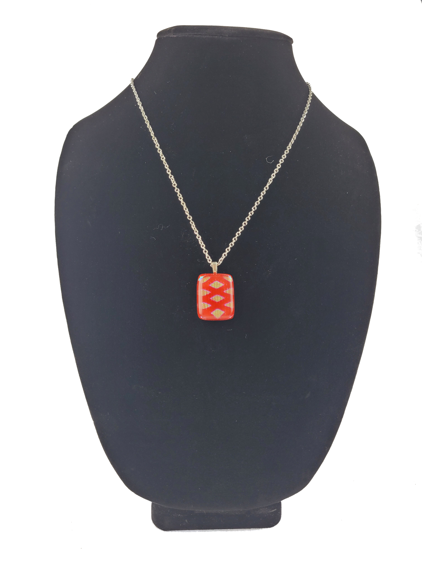 Necklace with a red pendant on a black bust