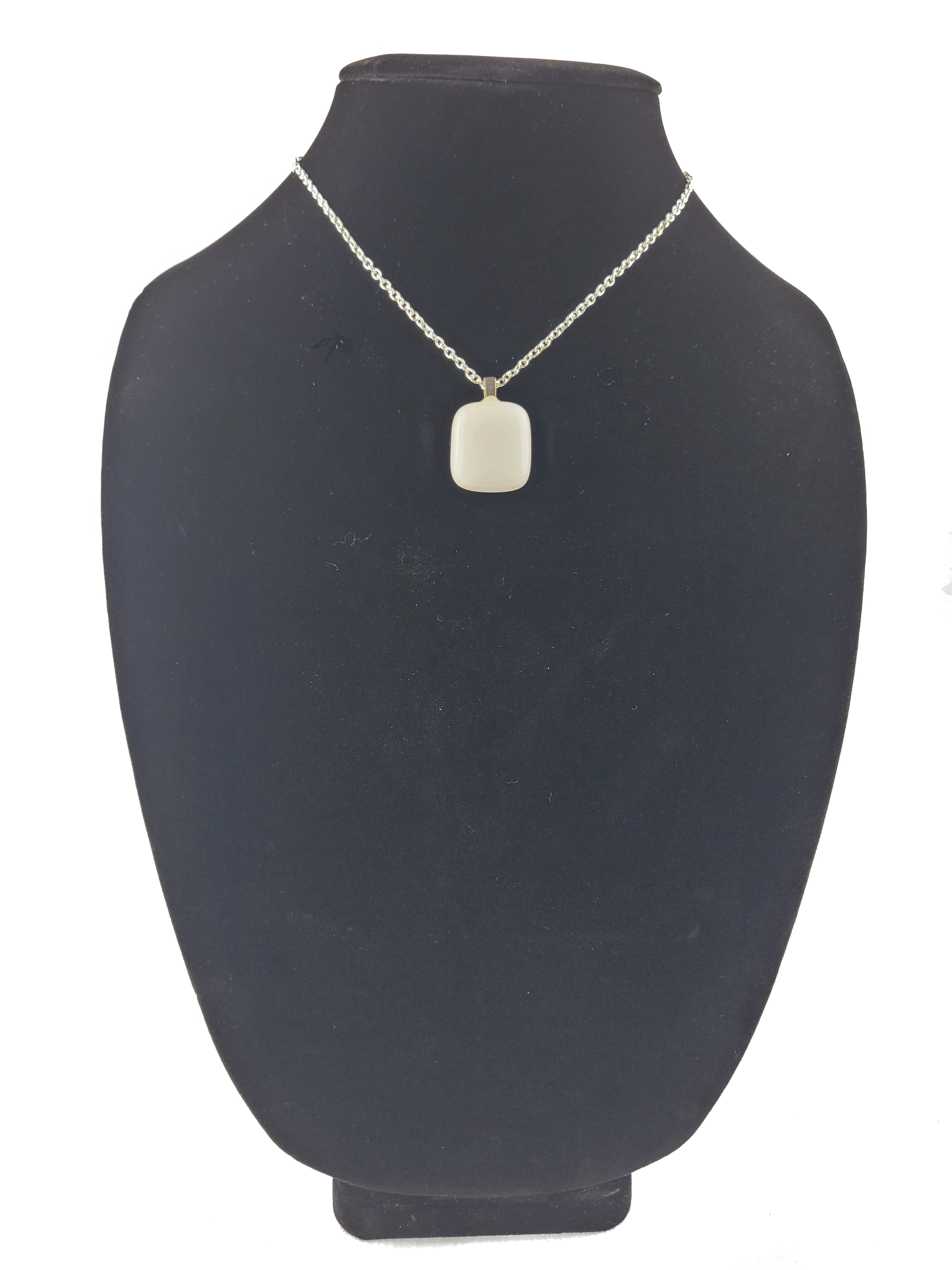 Necklace with a pendant on a black mannequin bust