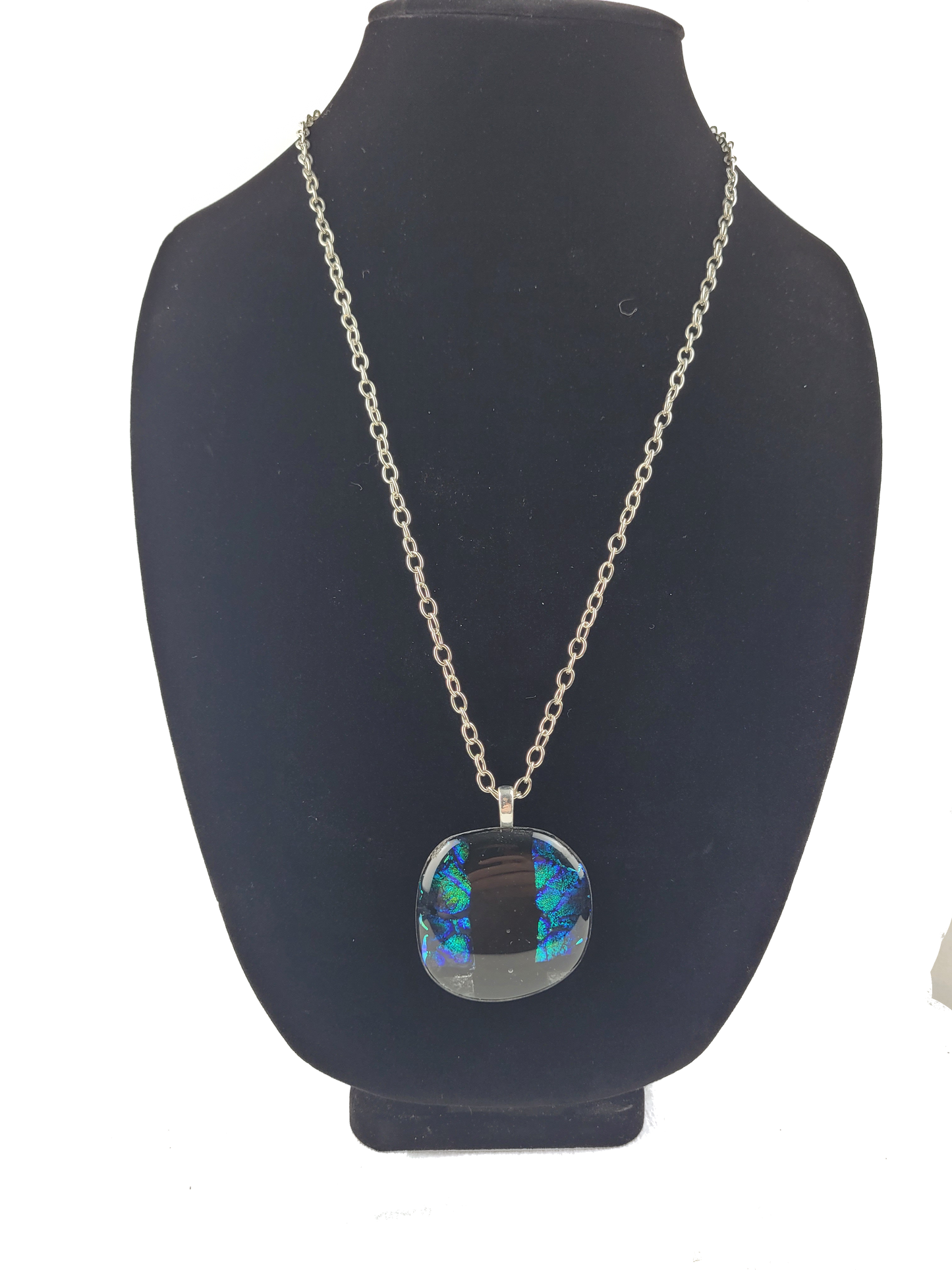 Necklace with a colorful pendant on a black bust