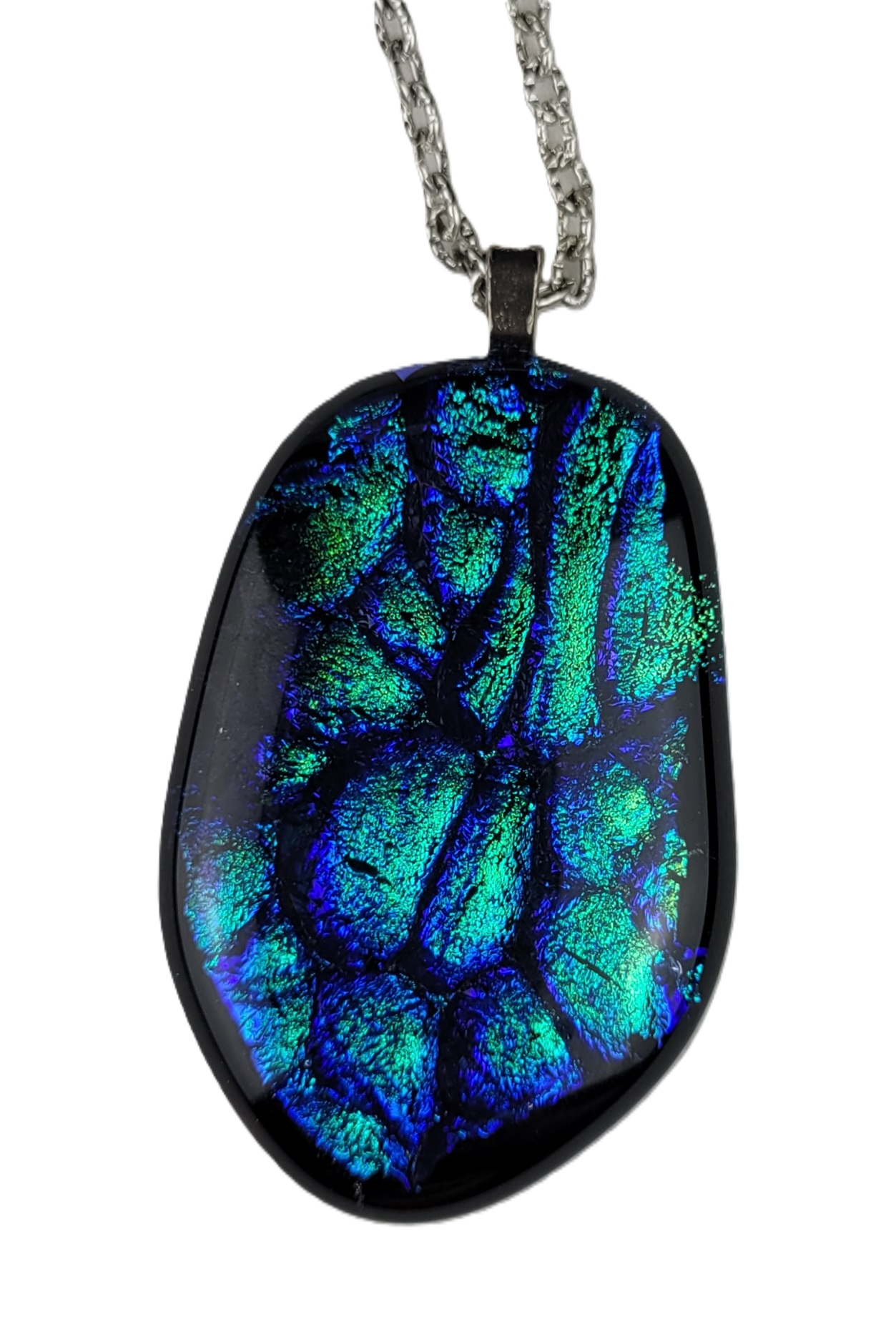 Oval-shaped pendant with blue and green patterns on a white background