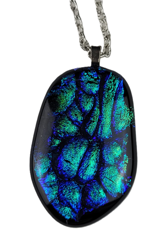 Oval-shaped pendant with blue and green patterns on a white background