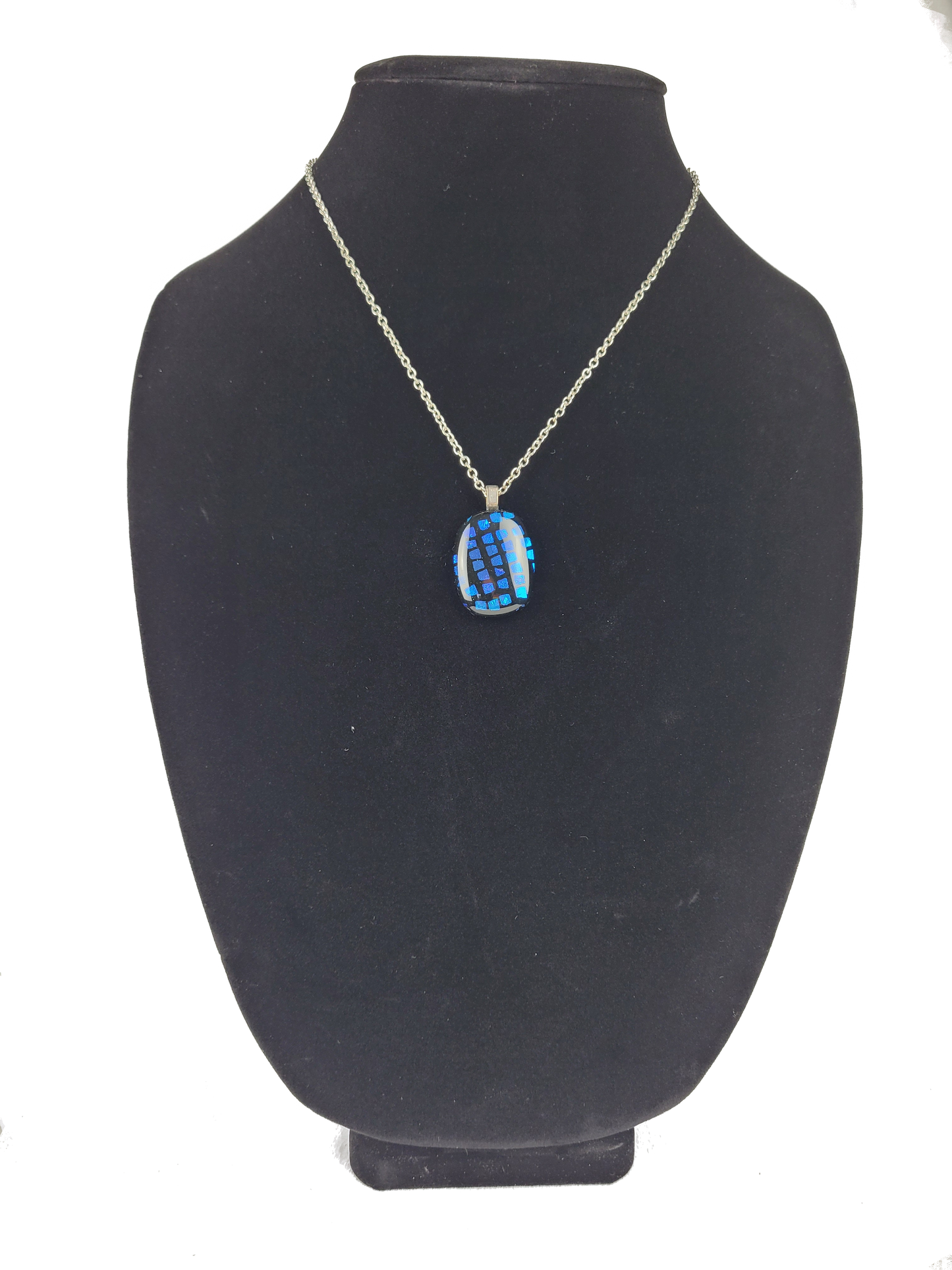 Necklace with a blue pendant on a black mannequin bust