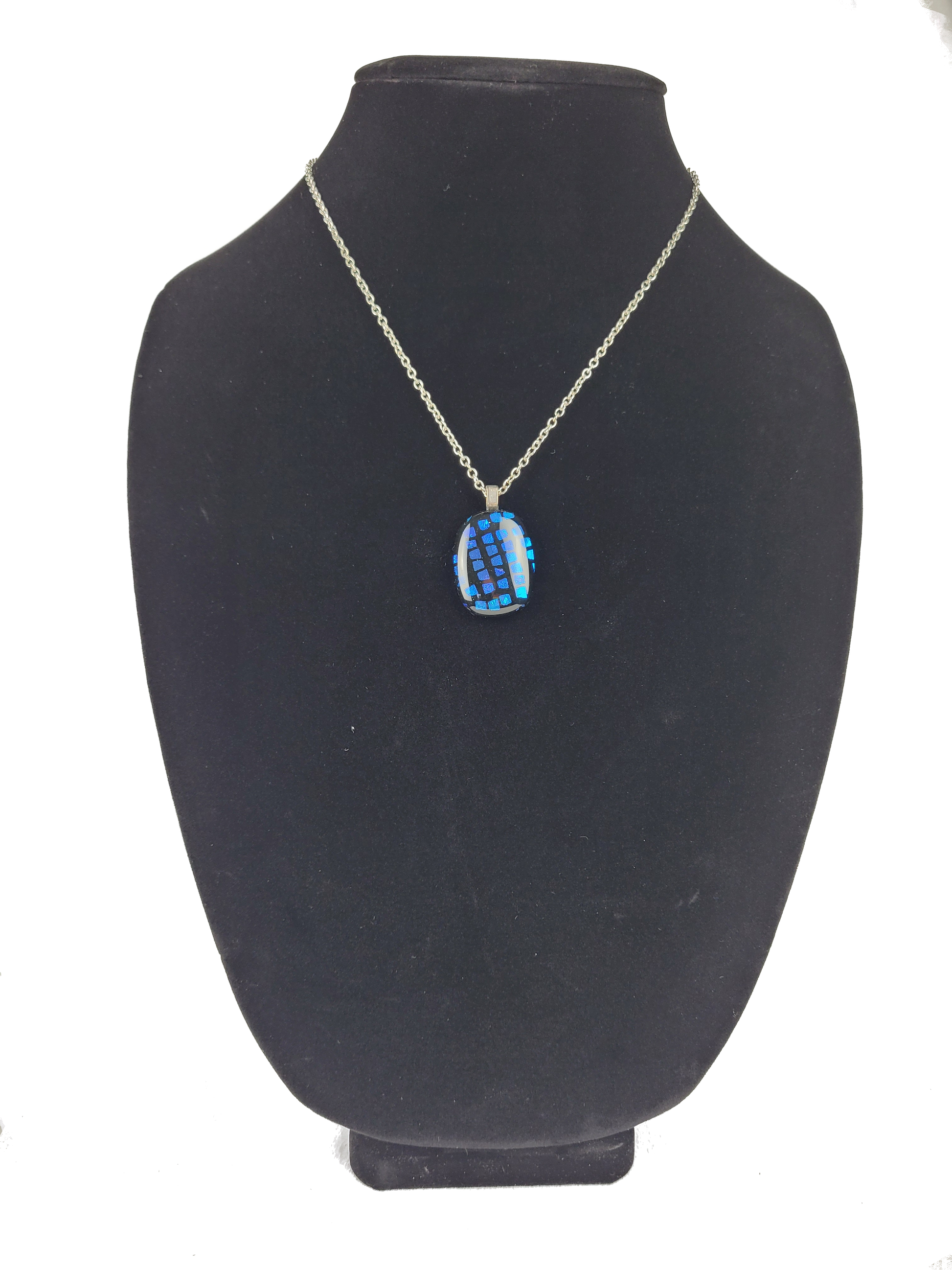 Necklace with a blue pendant on a black mannequin bust