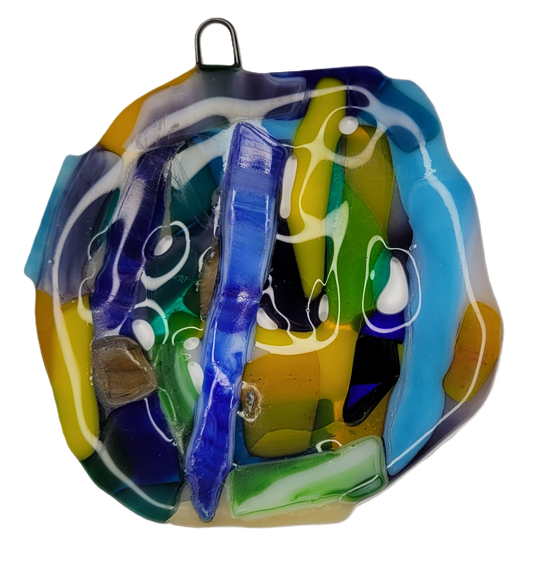 Colorful glass ornament with abstract design on a white background