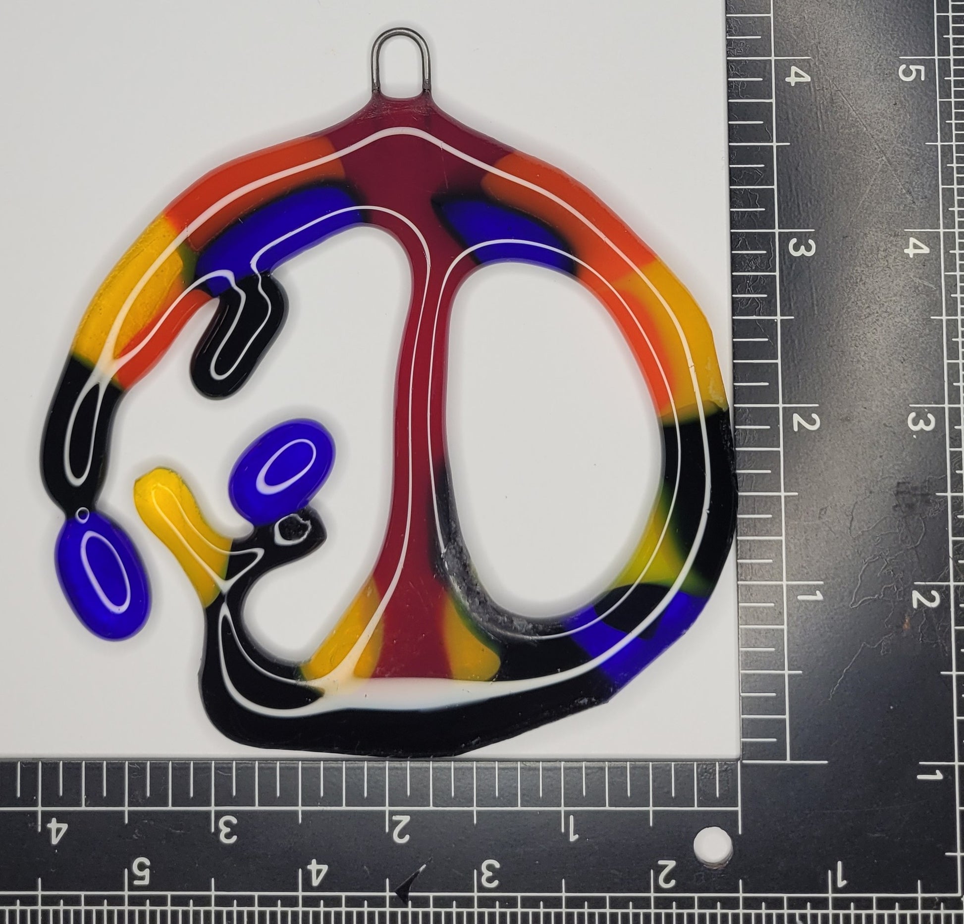 Colorful abstract design on a white background with a ruler for scale.