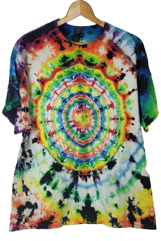 Colorful tie-dye t-shirt on a wooden hanger with a plain background
