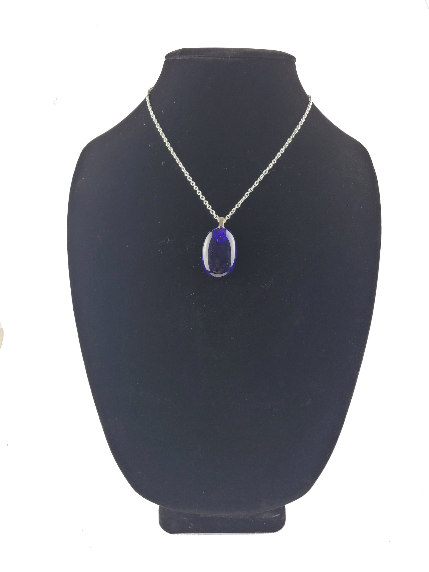 Necklace with a blue pendant on a black mannequin bust