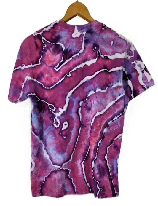 Marbled purple and pink t-shirt on a hanger with a white background