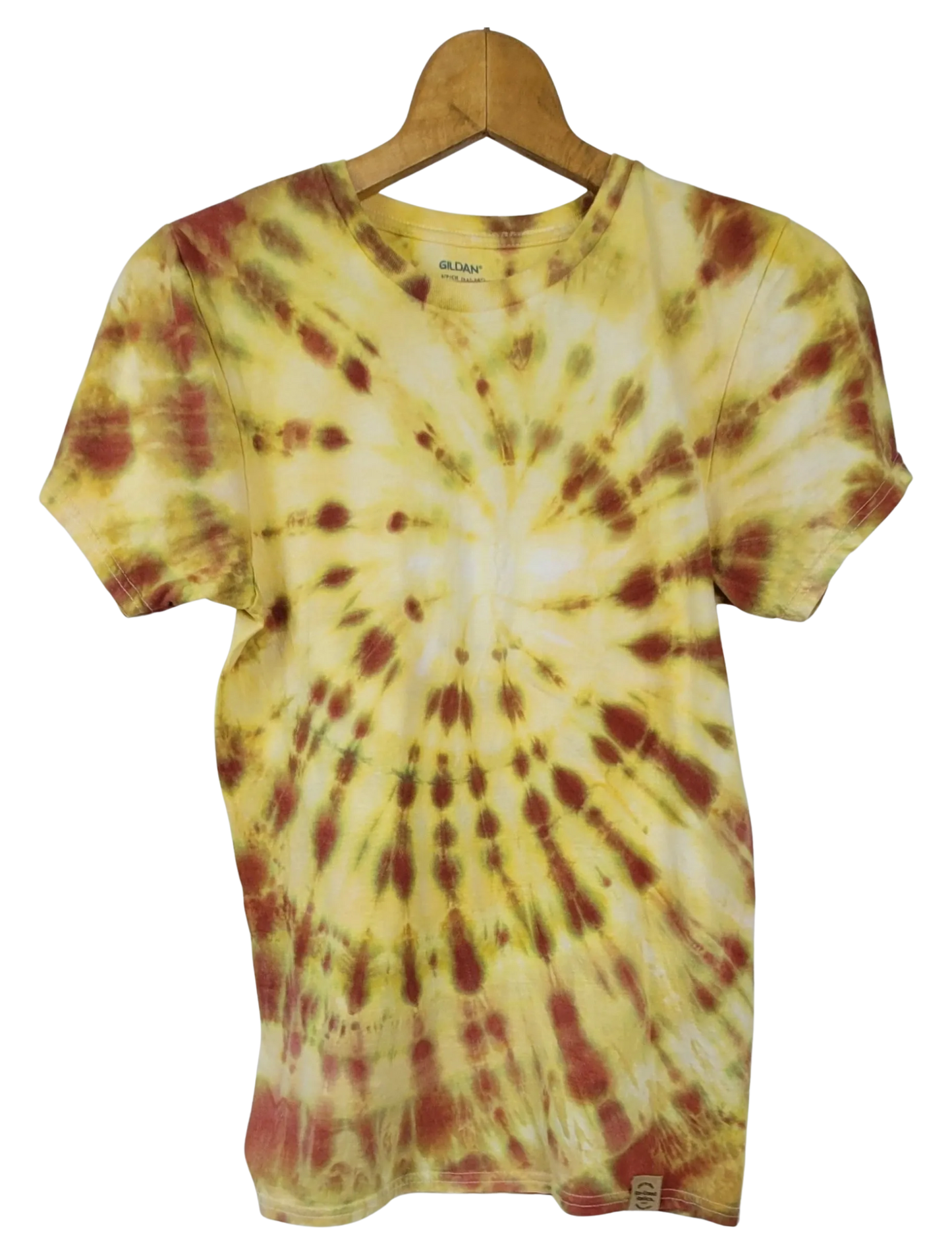Tie-dye t-shirt with yellow and red pattern on a hanger