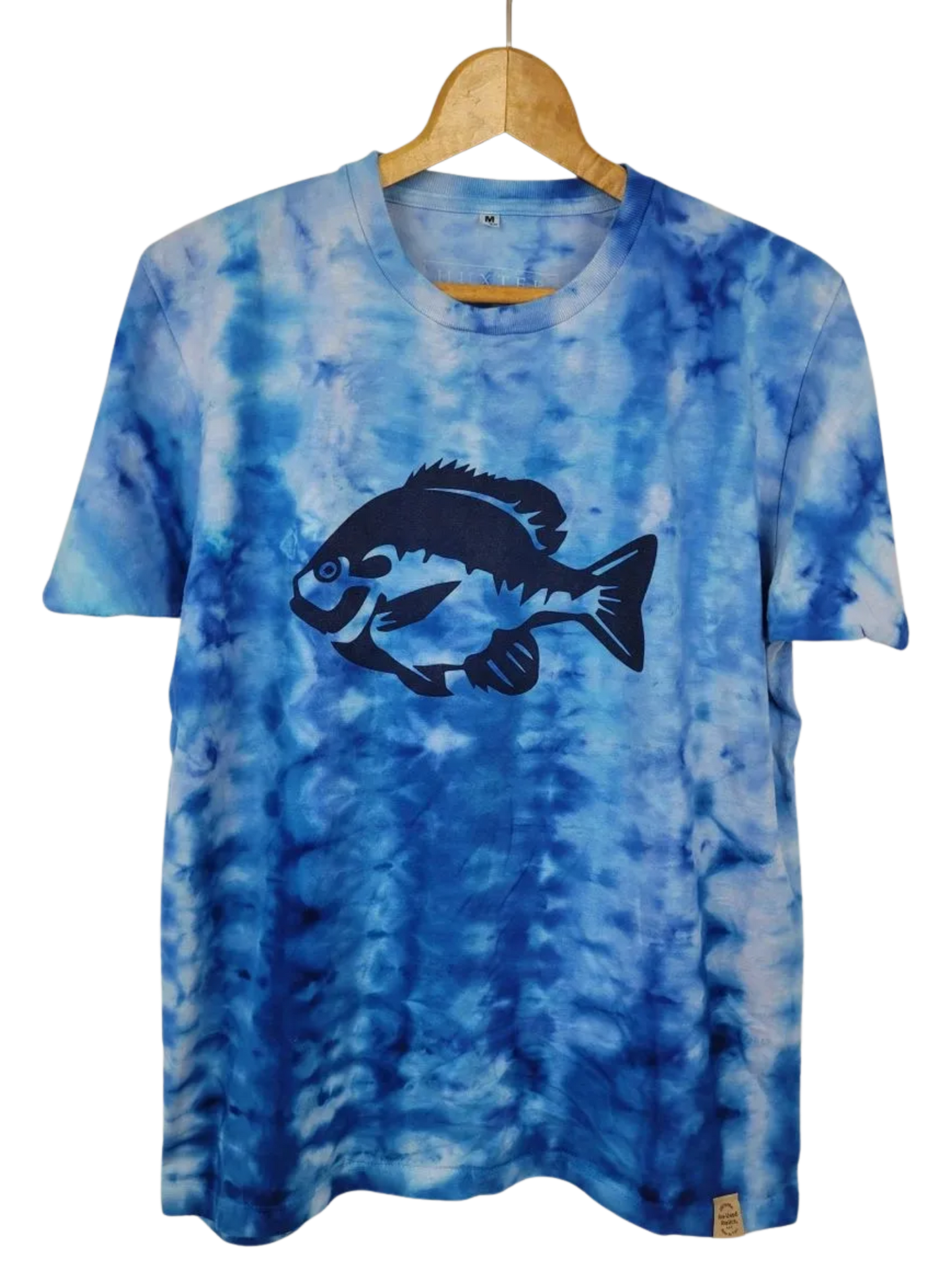 Blue tie-dye t-shirt with a fish graphic on a hanger