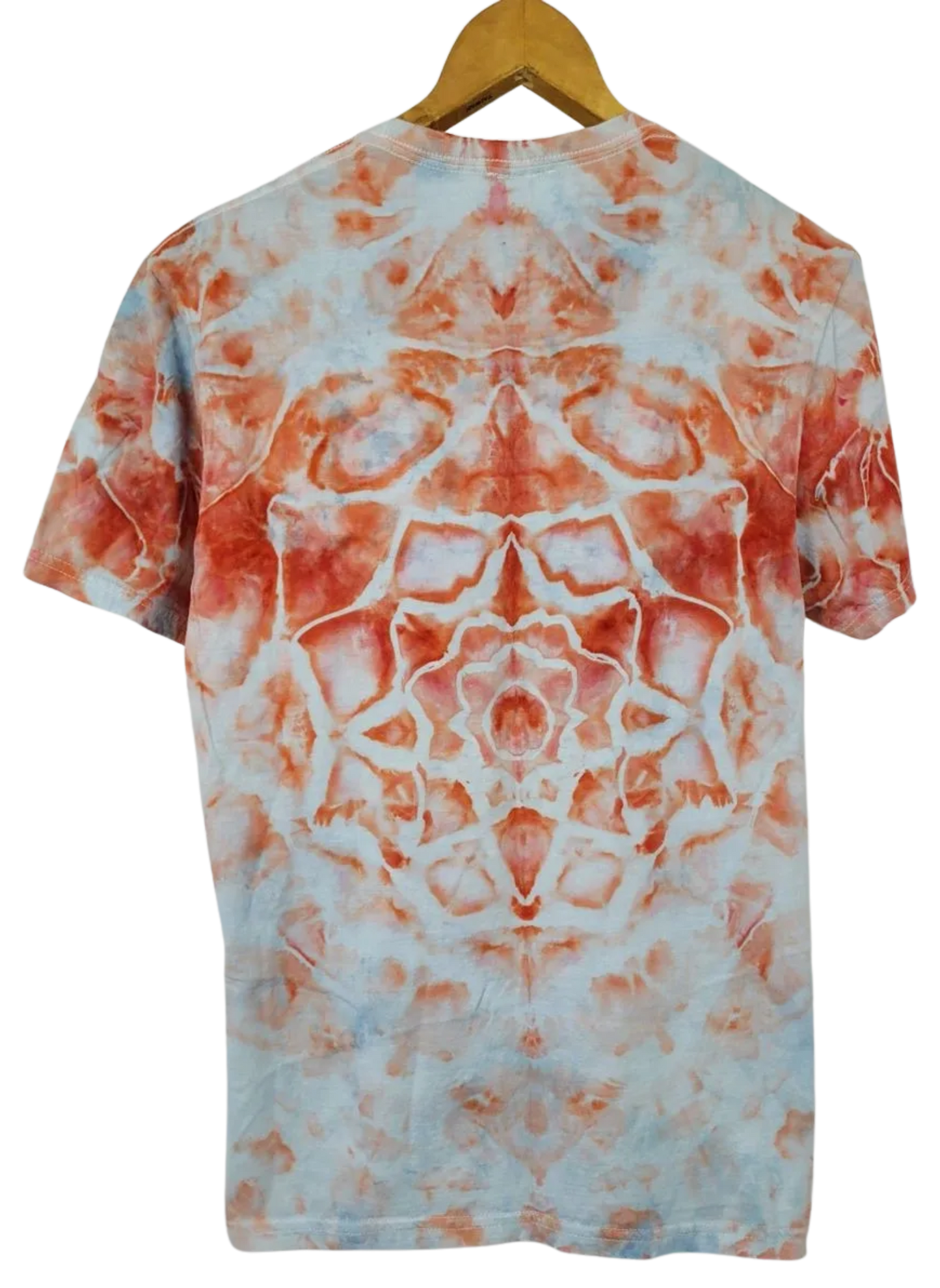 Tie-dye t-shirt with orange and white pattern on a hanger