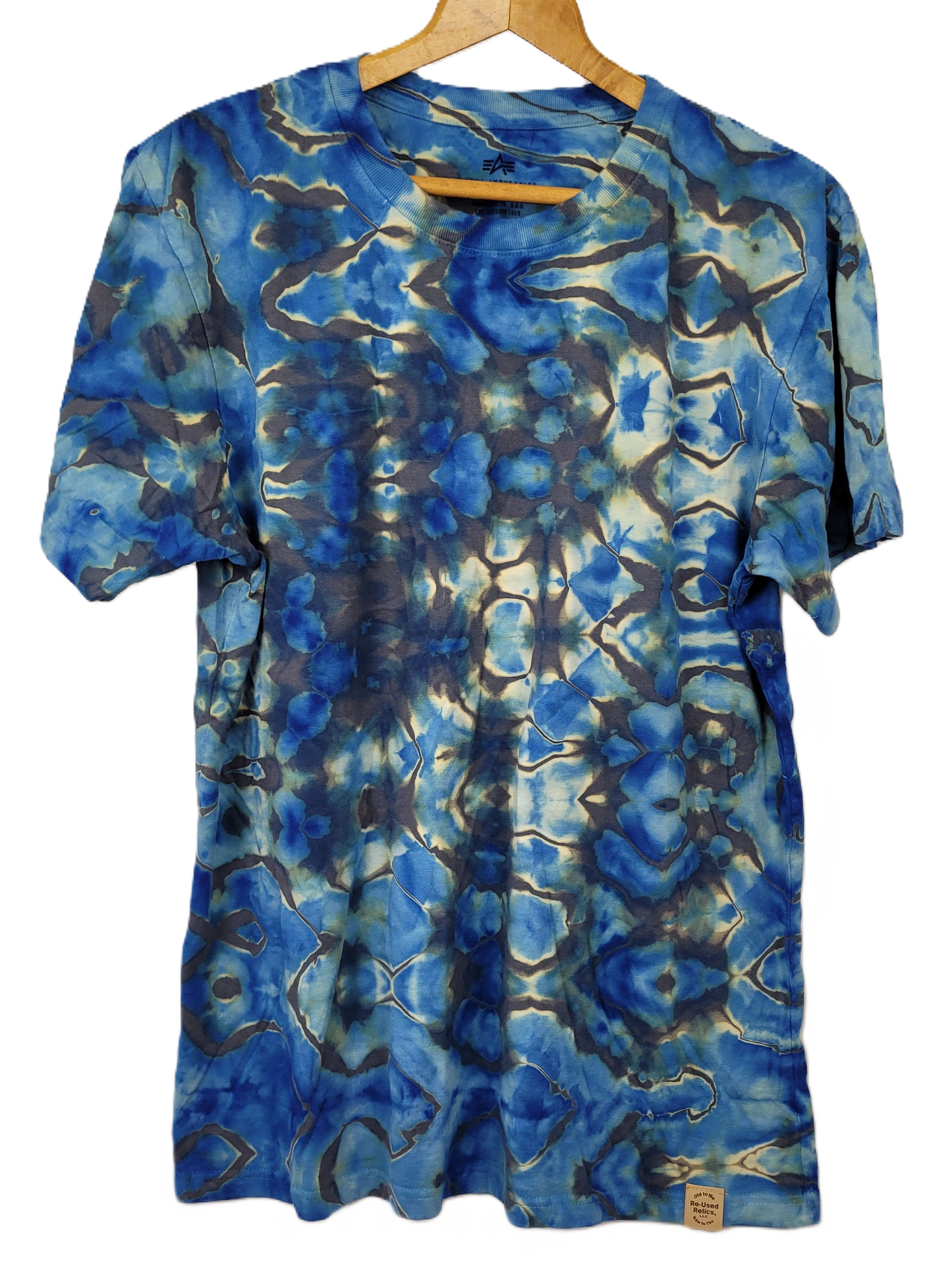 Blue tie-dye t-shirt on a hanger with a white background