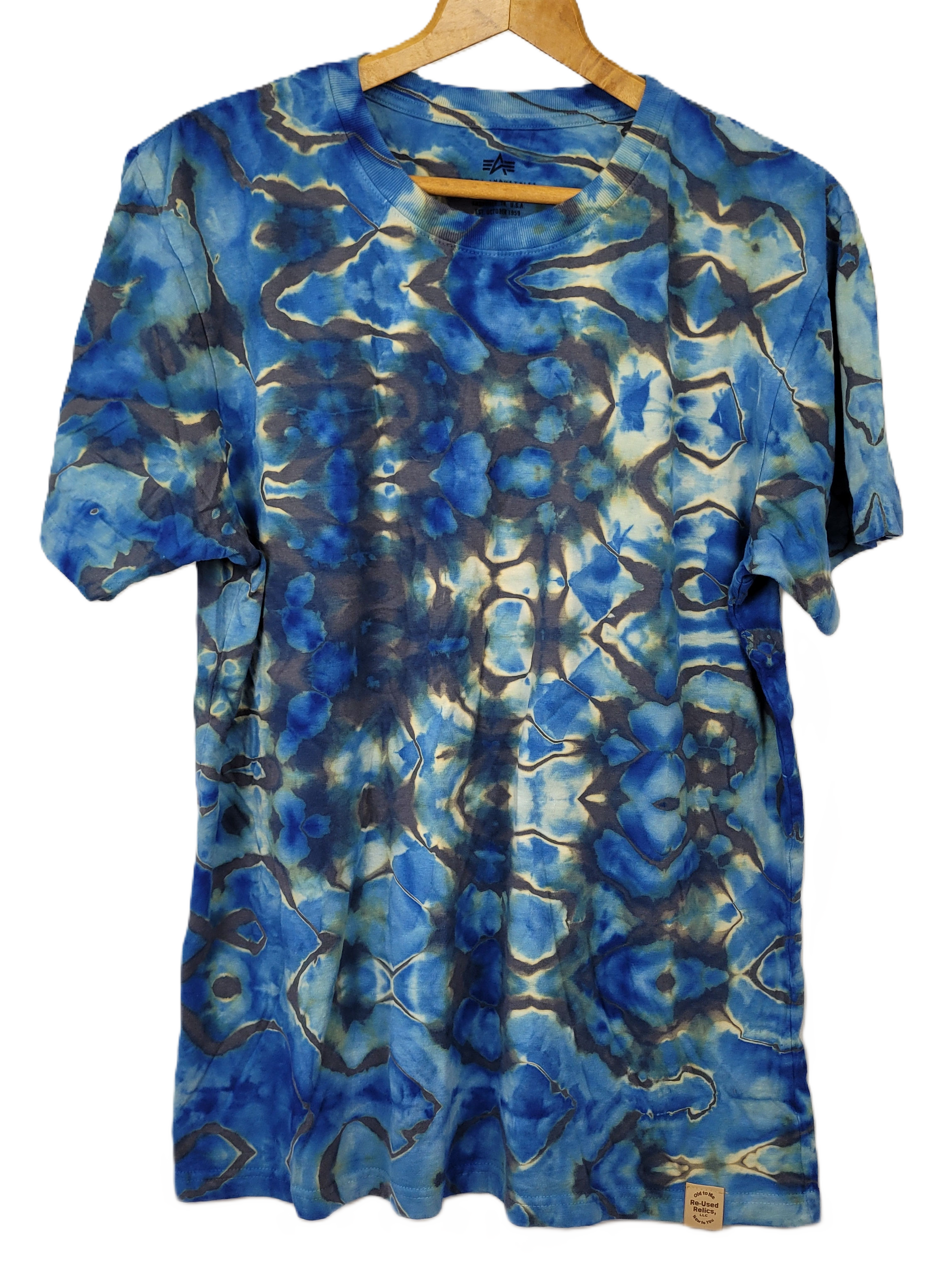 Blue tie-dye t-shirt on a hanger with a white background