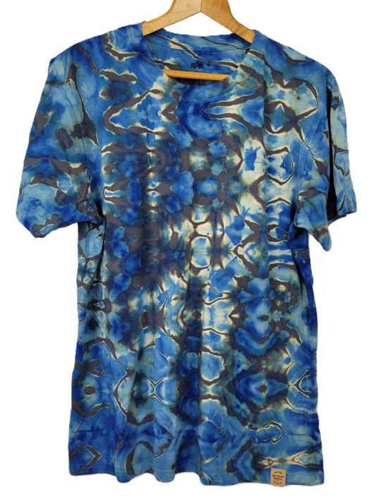 Blue tie-dye t-shirt on a hanger with a white background
