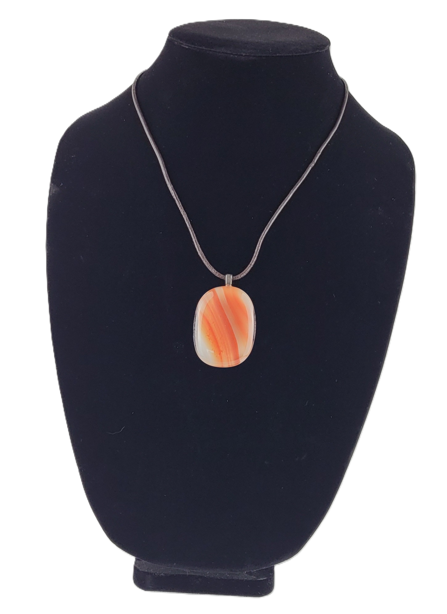 Necklace with an orange pendant on a black velvet stand