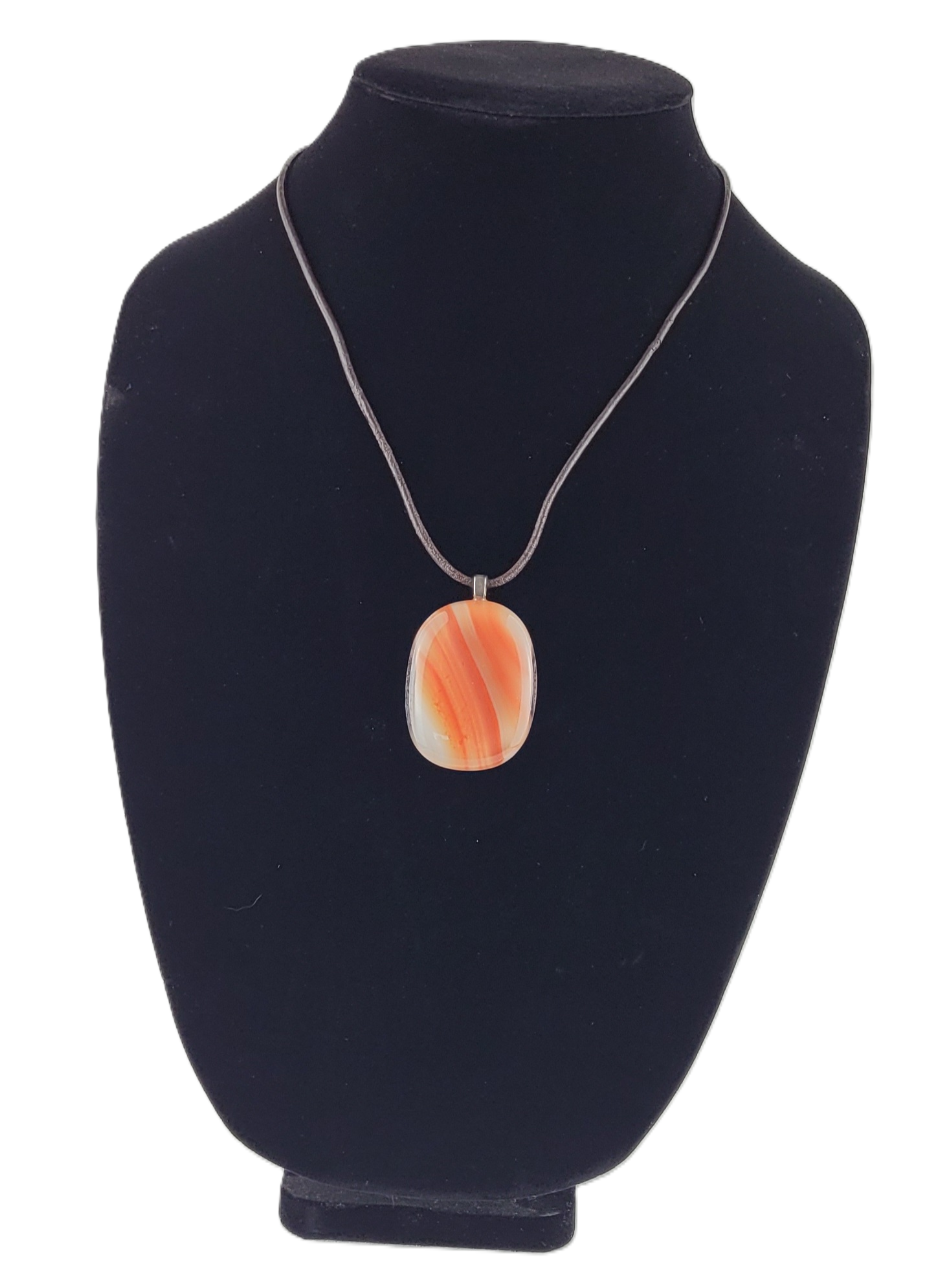 Necklace with an orange pendant on a black velvet stand