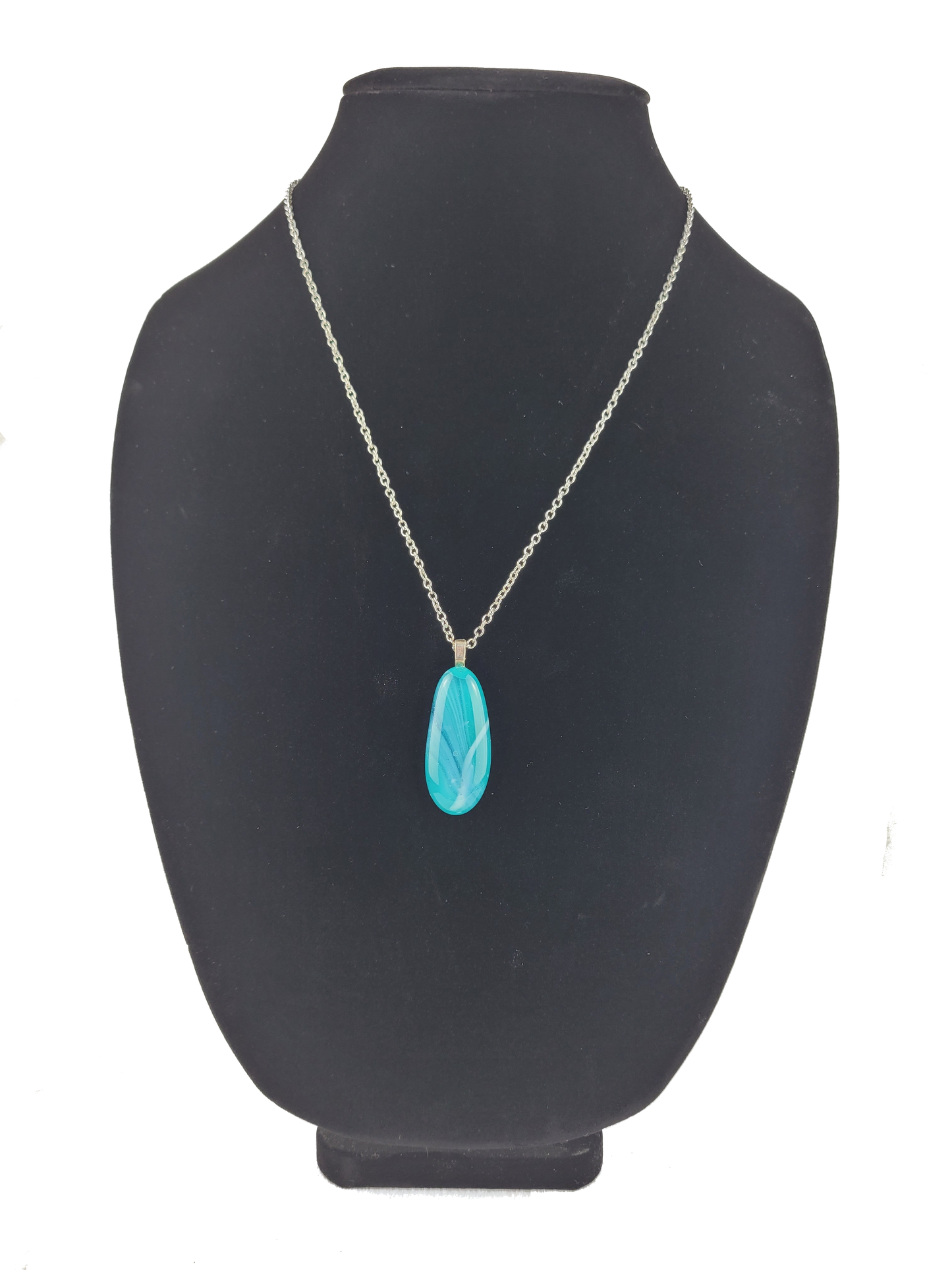 Turquoise pendant necklace on a black mannequin bust