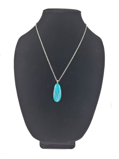 Turquoise pendant necklace on a black mannequin bust