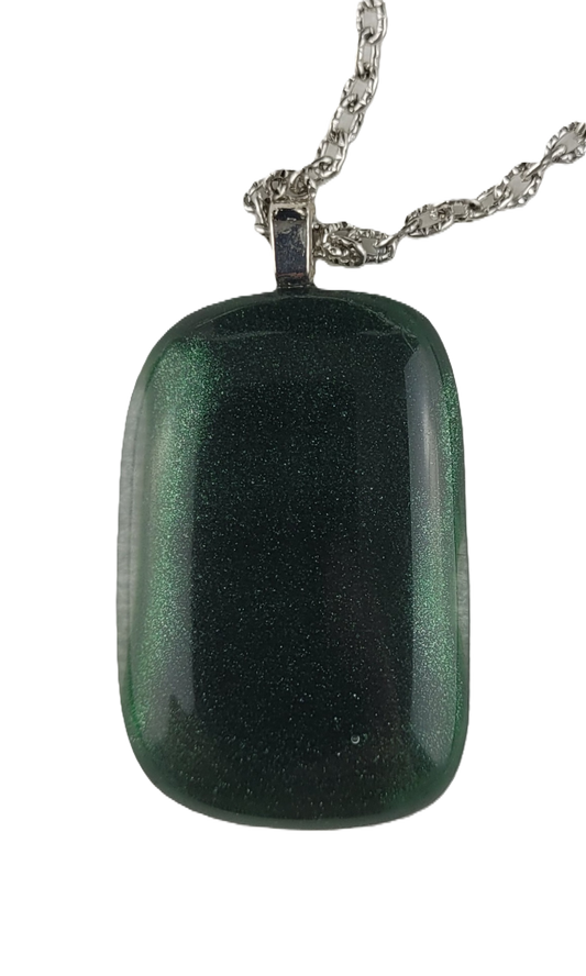 Green glass pendant on a chain against a white background