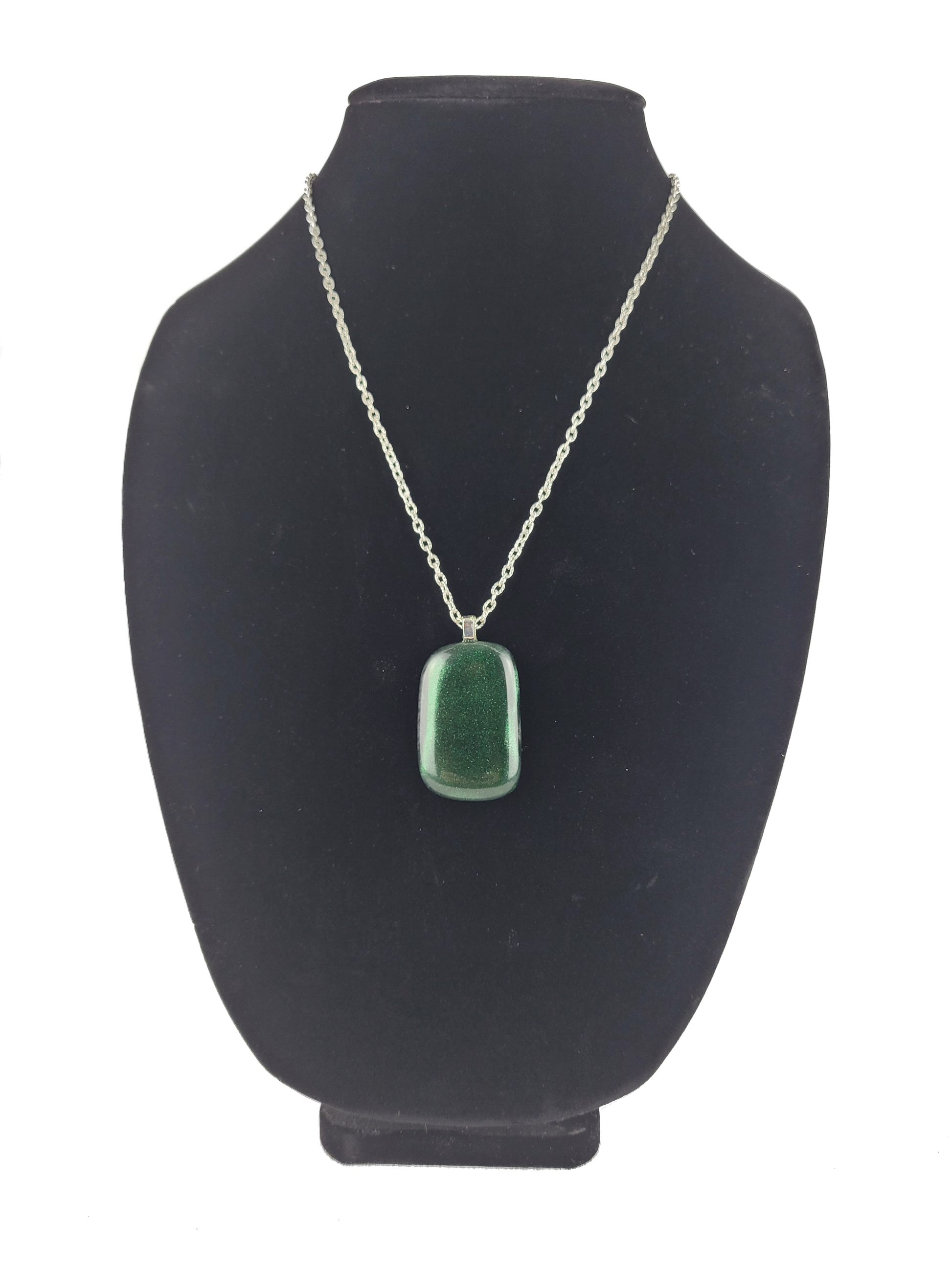 Green pendant necklace on a black bust