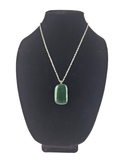 Green pendant necklace on a black bust