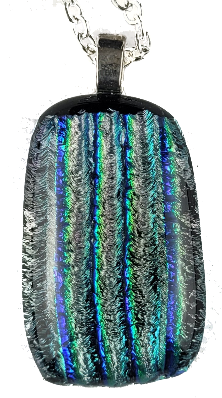 Multicolored dichroic glass pendant on a white background