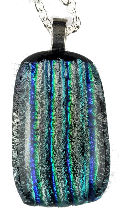 Multicolored dichroic glass pendant on a white background