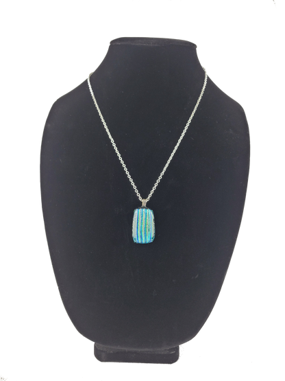 Necklace with a blue pendant on a black bust