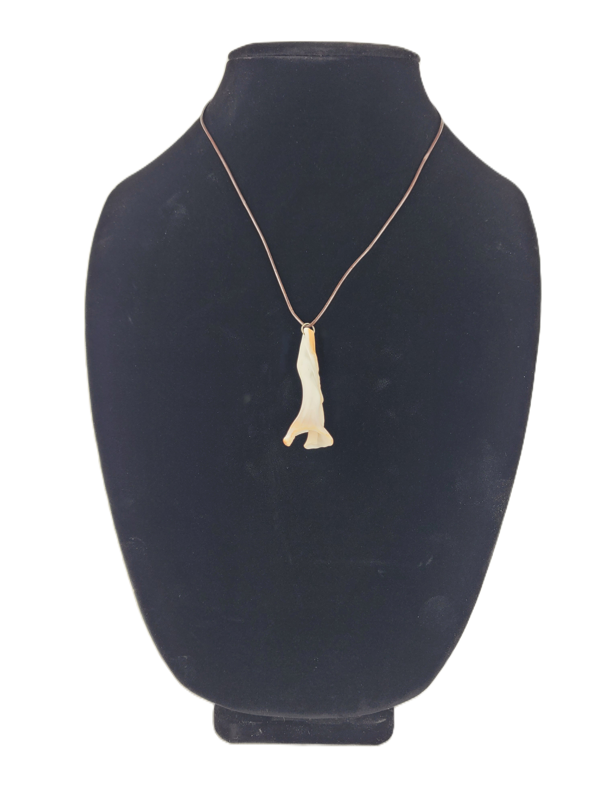 necklace with a pendant on a black mannequin bust
