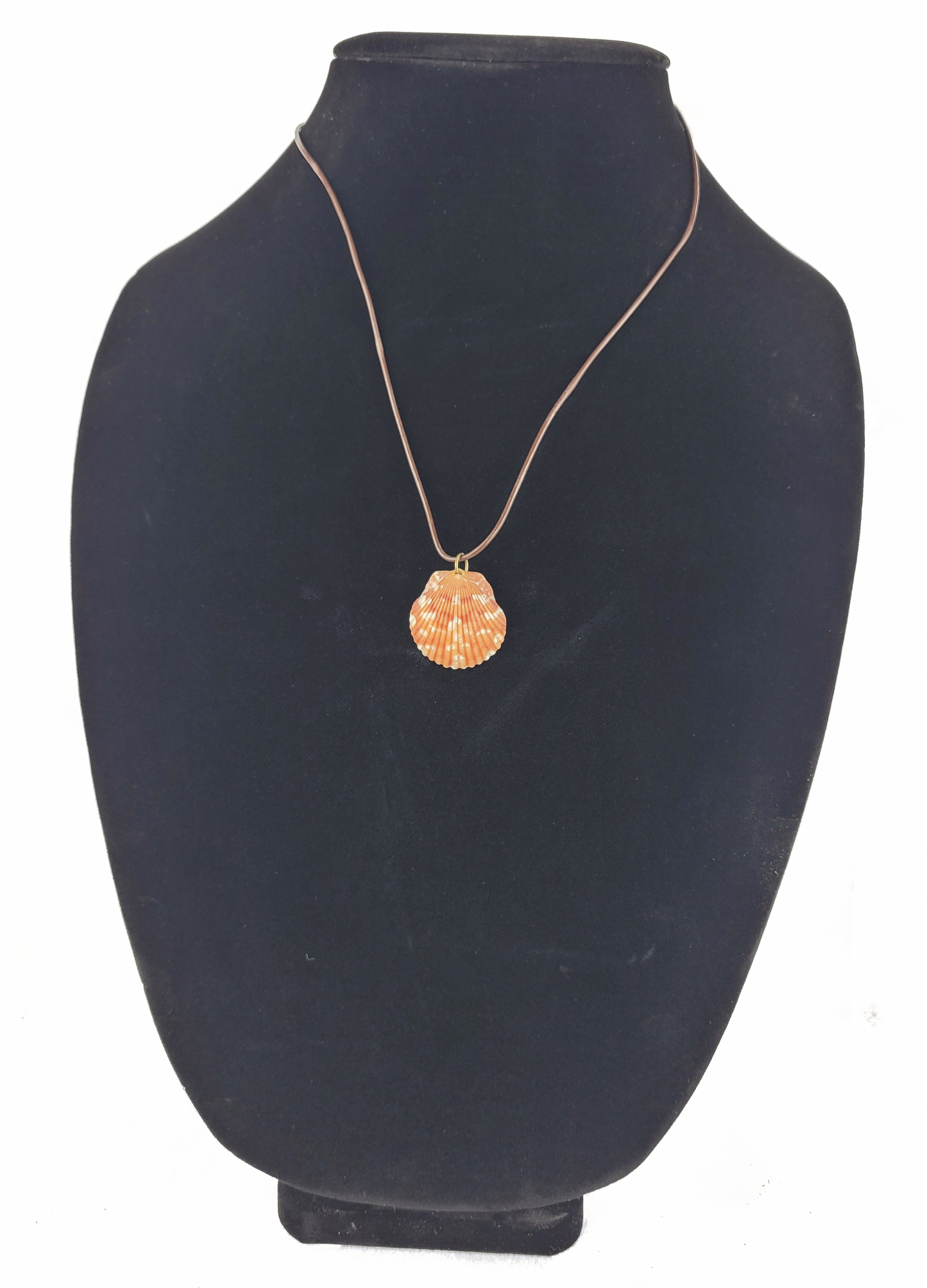 Necklace with a round pendant on a black mannequin bust