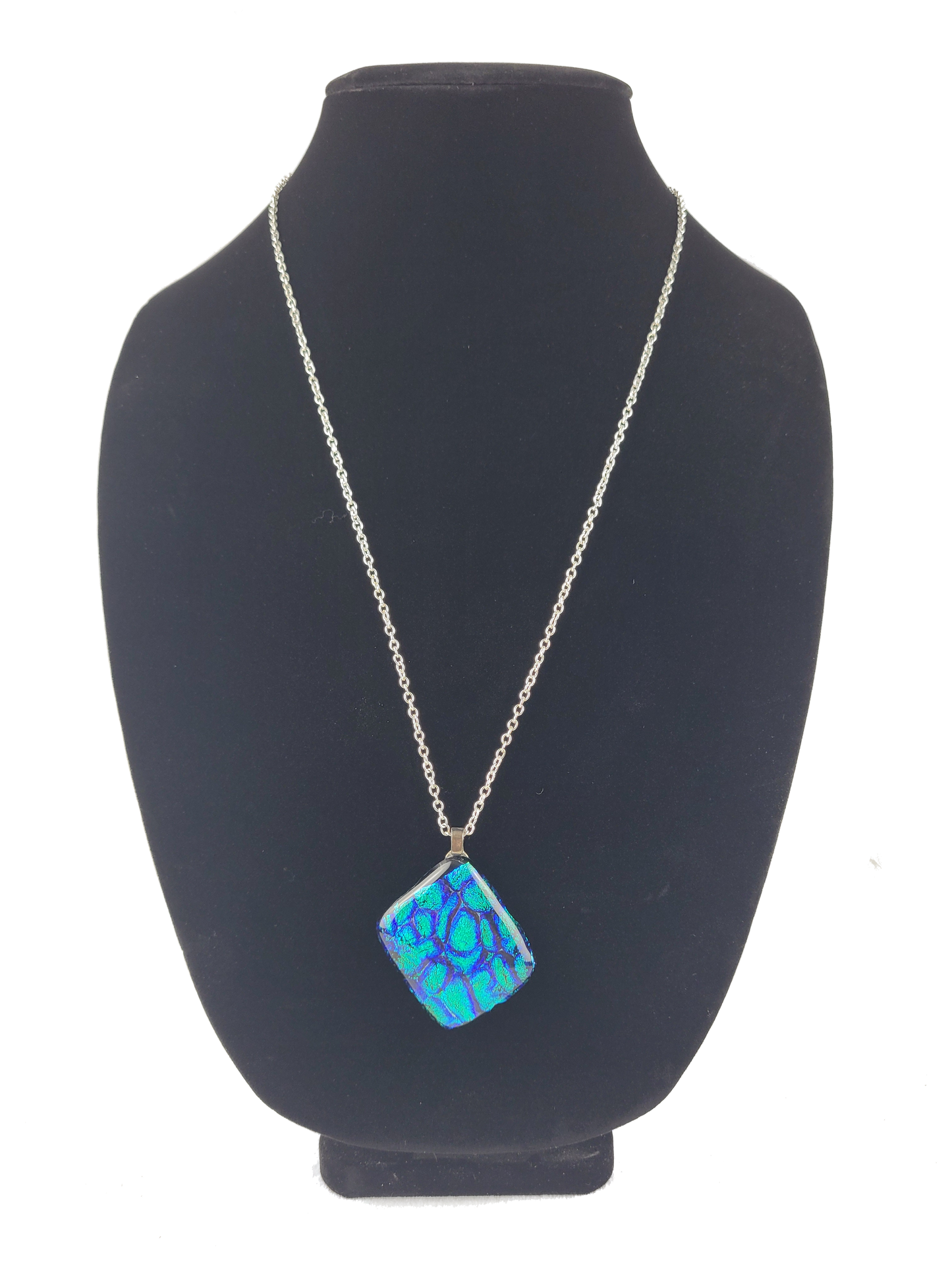 Necklace with a blue pendant on a black mannequin bust