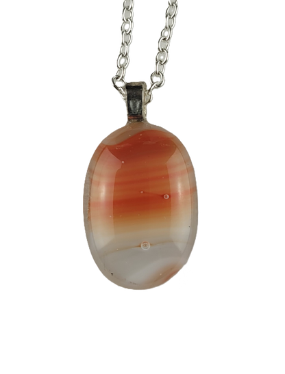 Necklace with an oval pendant featuring red and white patterns on a white background