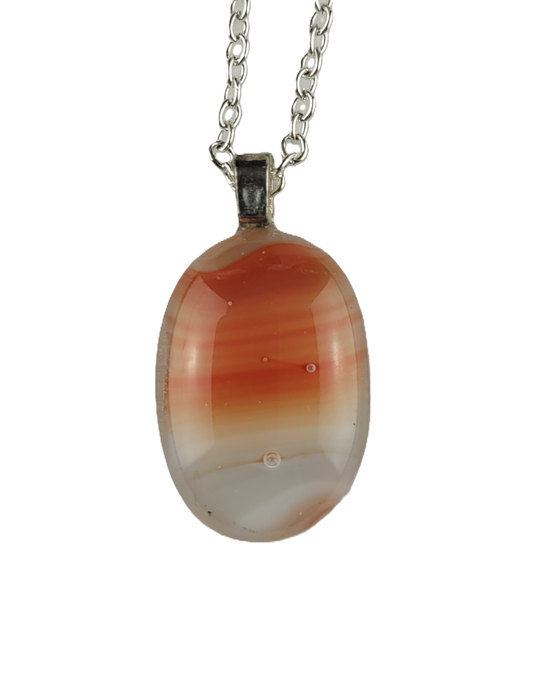 Necklace with an oval pendant featuring red and white patterns on a white background