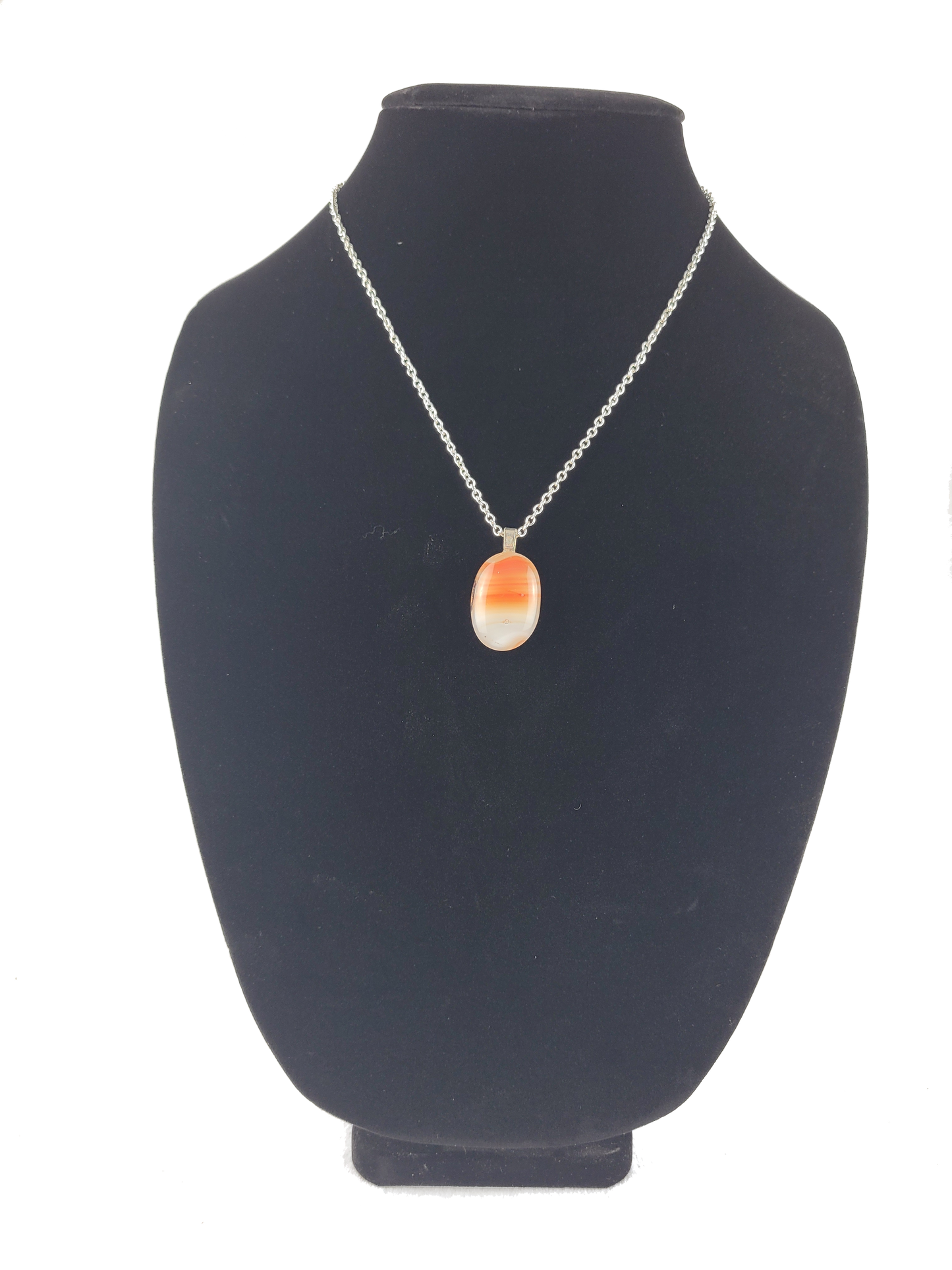 Necklace with a pendant on a black bust