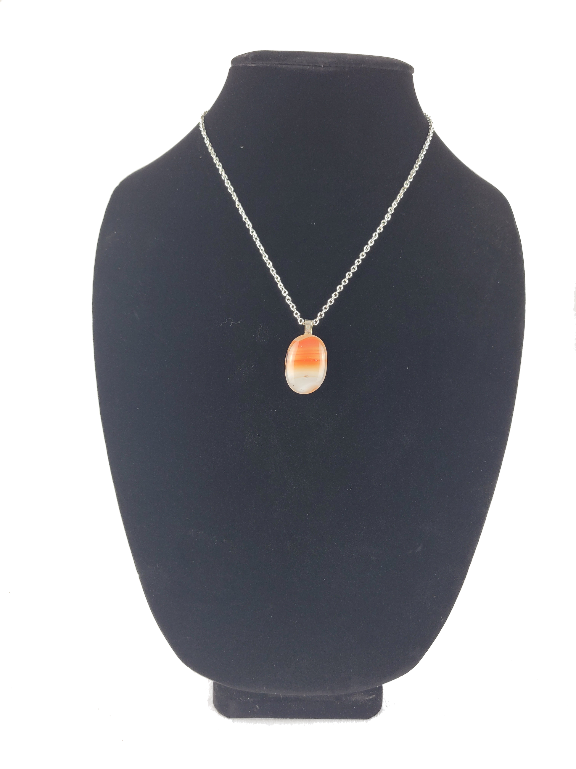 Necklace with a pendant on a black bust