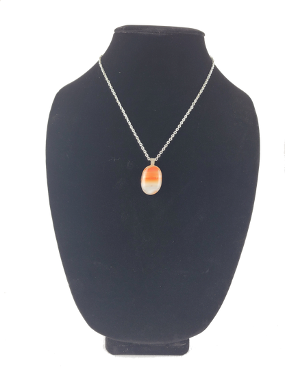 Necklace with a pendant on a black bust