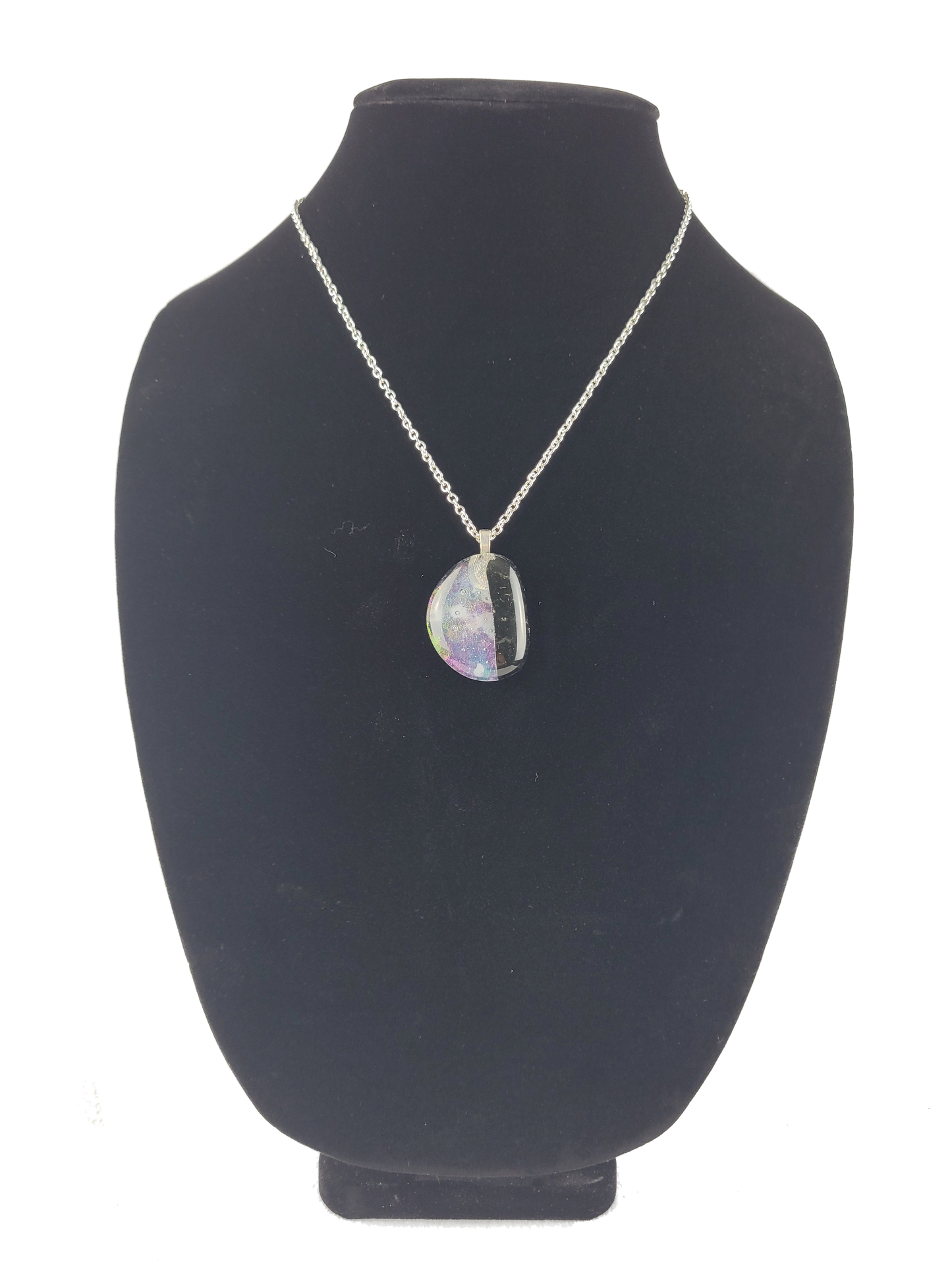 Necklace with a pendant on a black bust