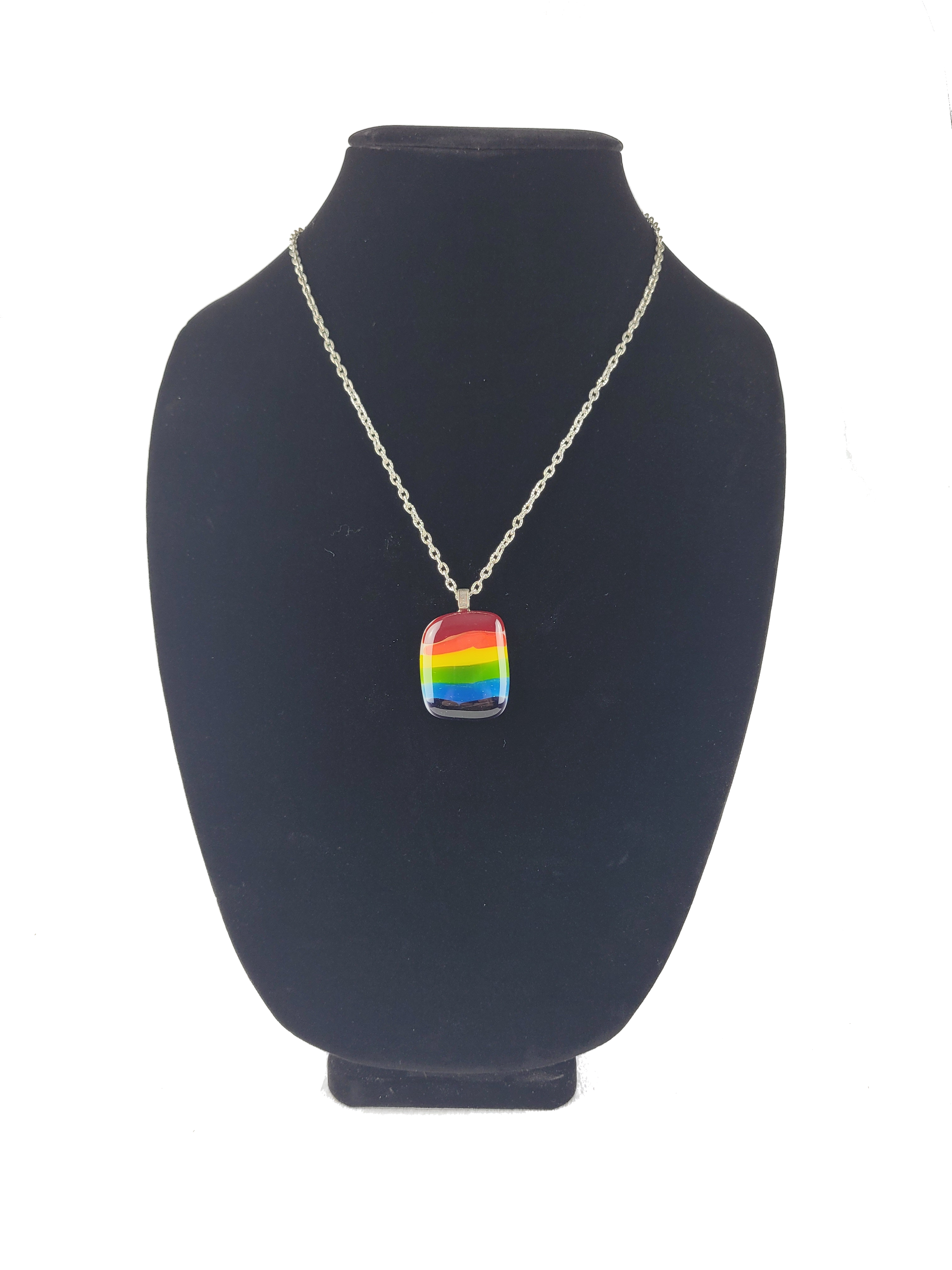 Necklace with a rainbow pendant on a black bust