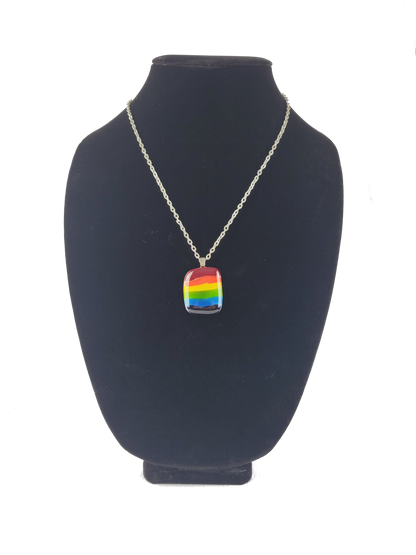 Necklace with a rainbow pendant on a black bust