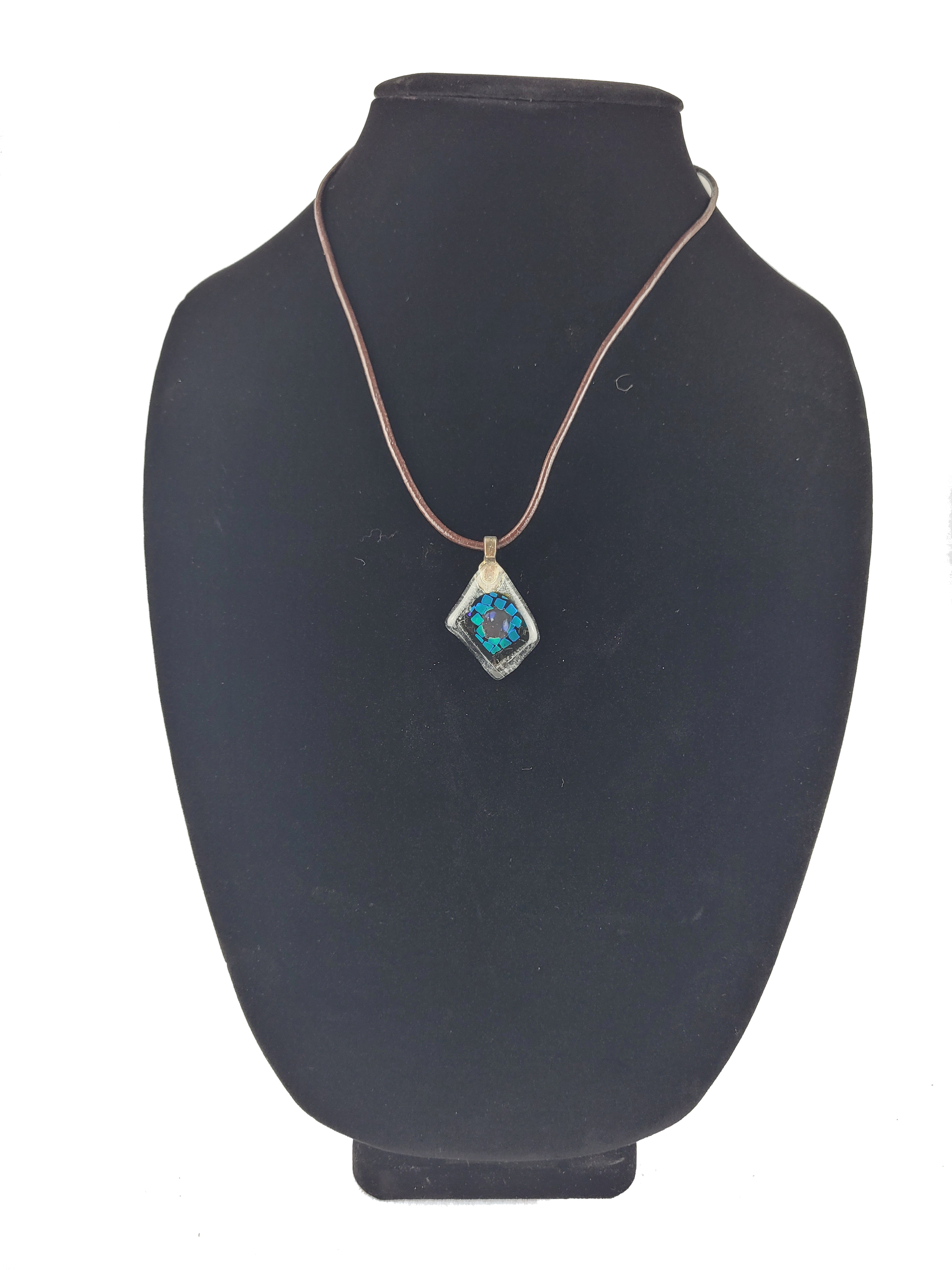 Necklace with a blue pendant on a black mannequin bust