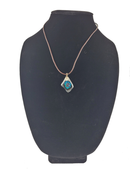 Necklace with a blue pendant on a black mannequin bust