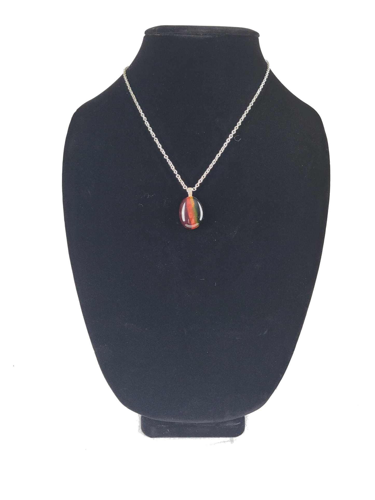 Necklace with a colorful pendant on a black velvet stand