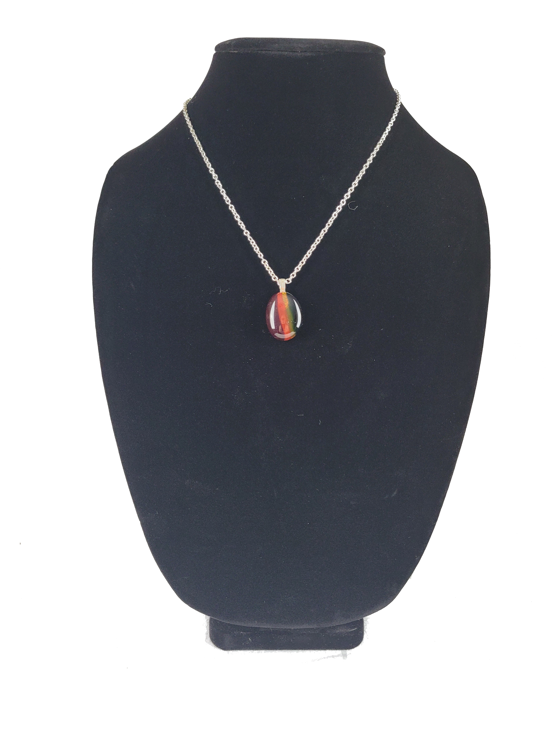 Necklace with a colorful pendant on a black velvet stand