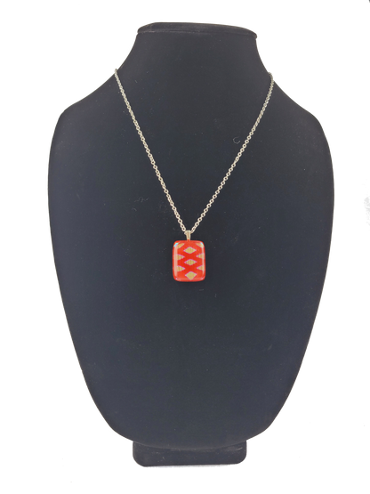 Necklace with a red pendant on a black bust