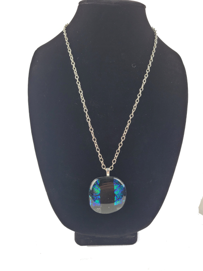 Necklace with a colorful pendant on a black bust