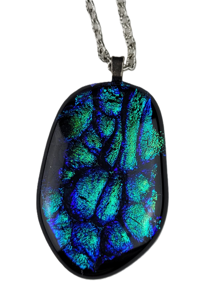 Oval-shaped pendant with blue and green patterns on a white background
